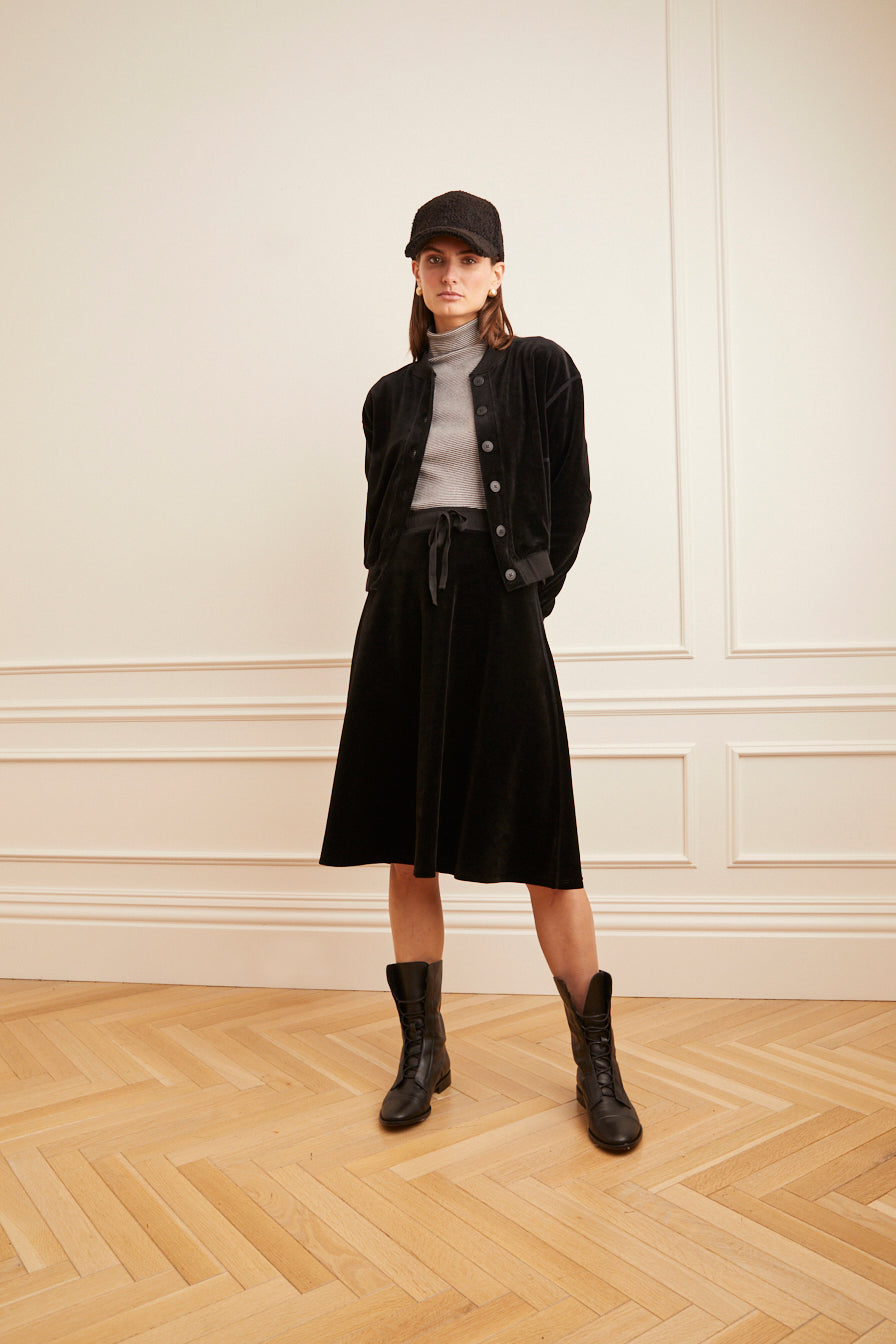 Model wearing the Velour Drawstring Short Skirt in black.
