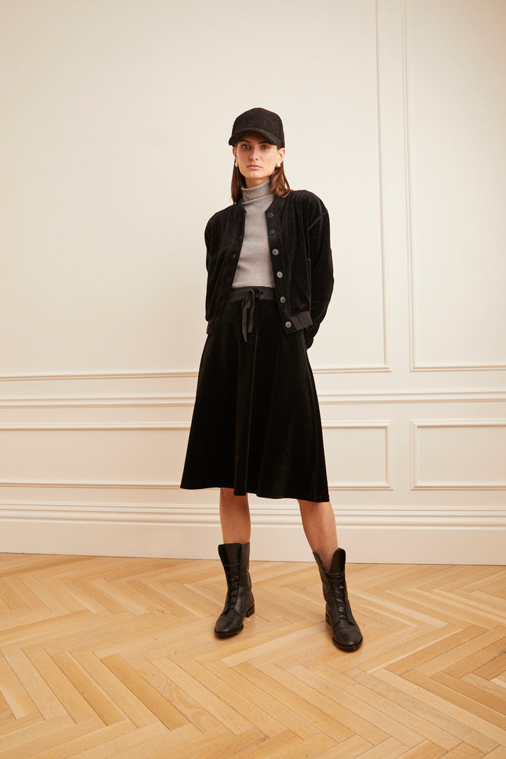 Model wearing the Velour Drawstring Short Skirt in black.