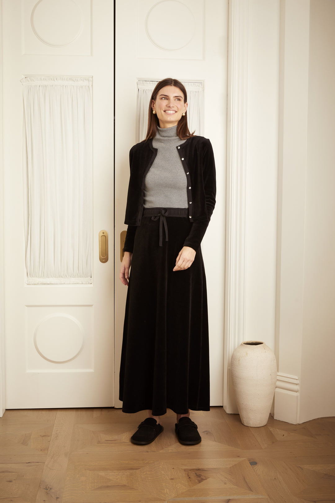 Model wearing the Velour Drawstring Maxi Skirt in black.