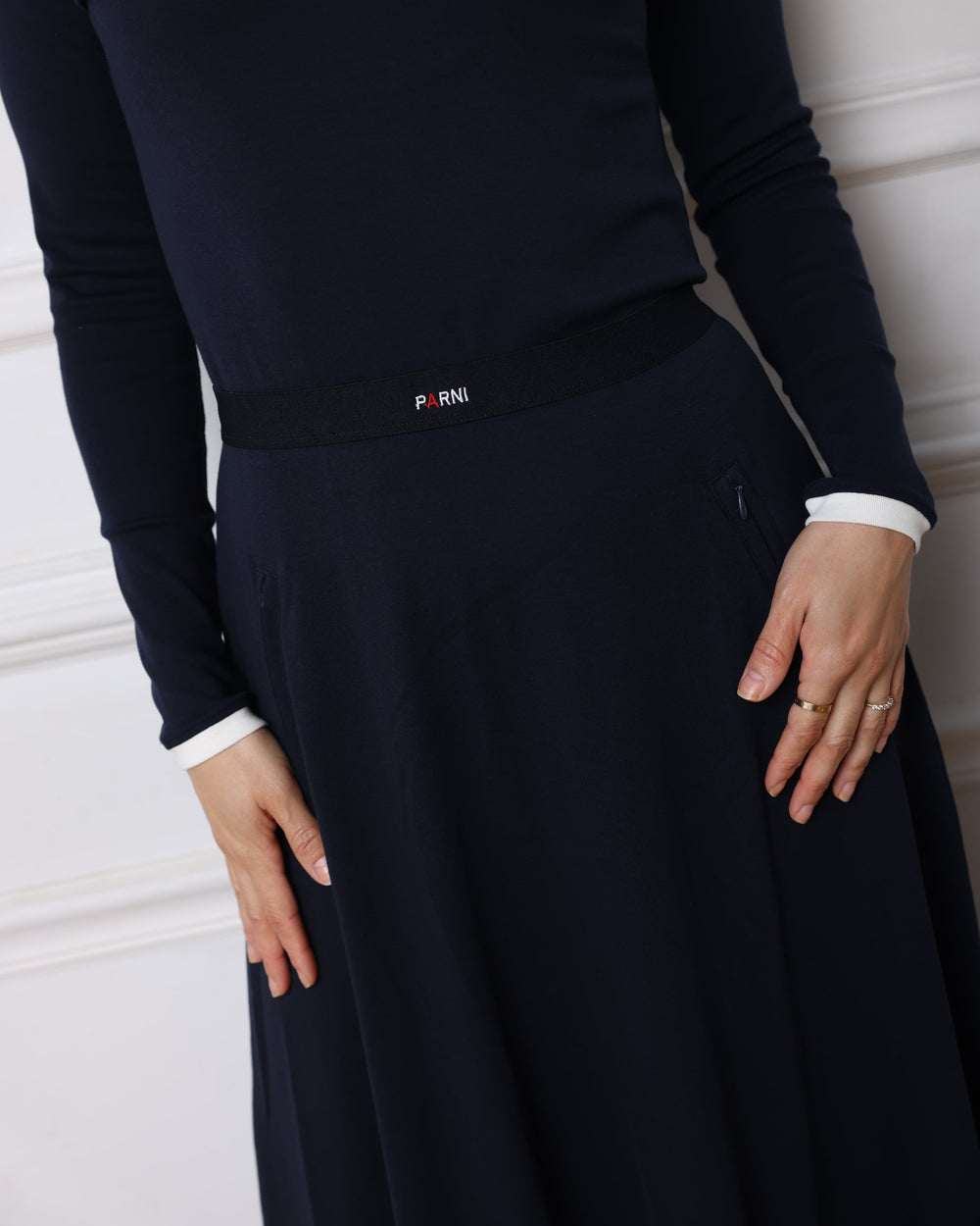 Navy blue coat with white trim on a white background
