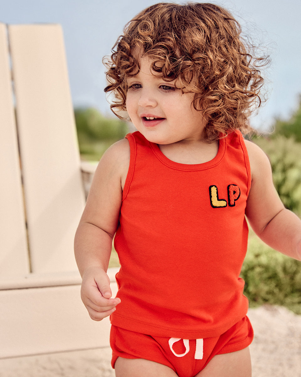 Baby wearing the LP Baby Tank and Short Set in Orange.
