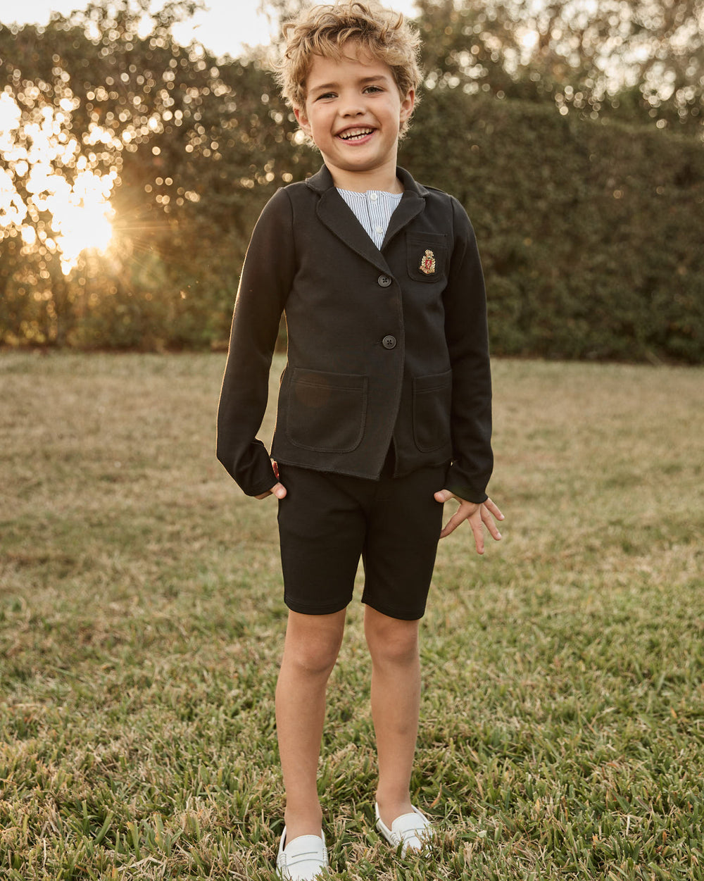 Boy wearing the Milano Classic Blazer with Crest in Black.