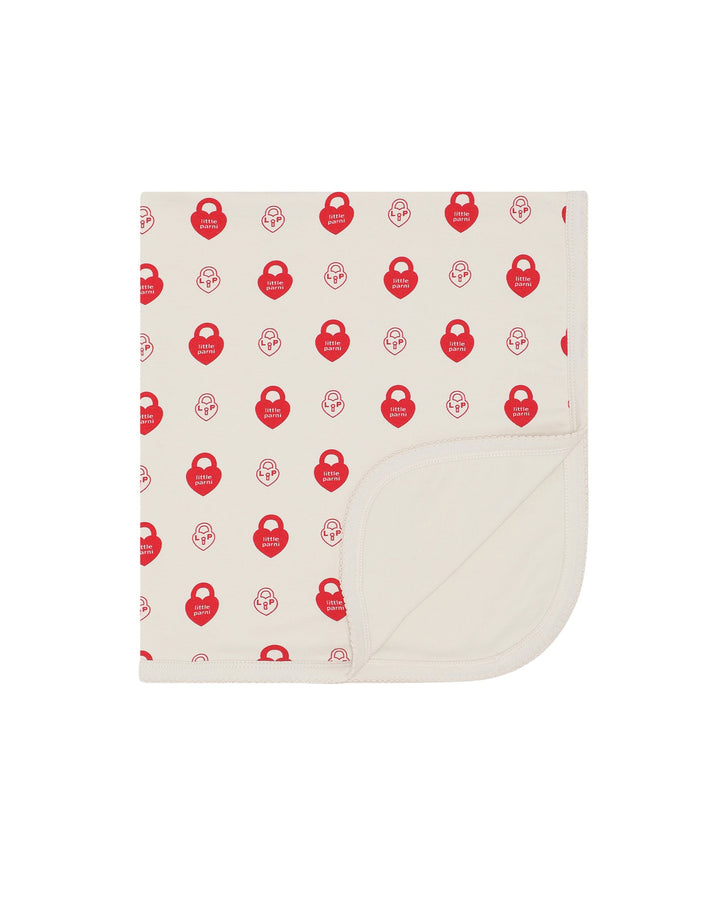 Baby blanket with red pattern on a white background