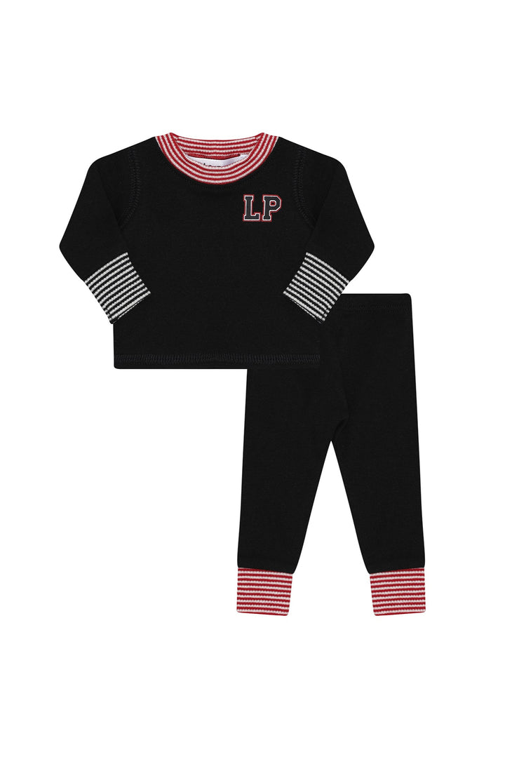 Black doll pajama set with red and white trim on a white background.