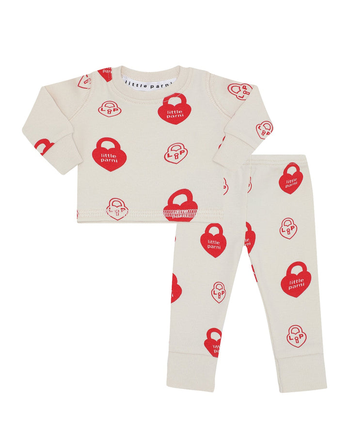 Doll pajama set with red and white pattern on a white background.