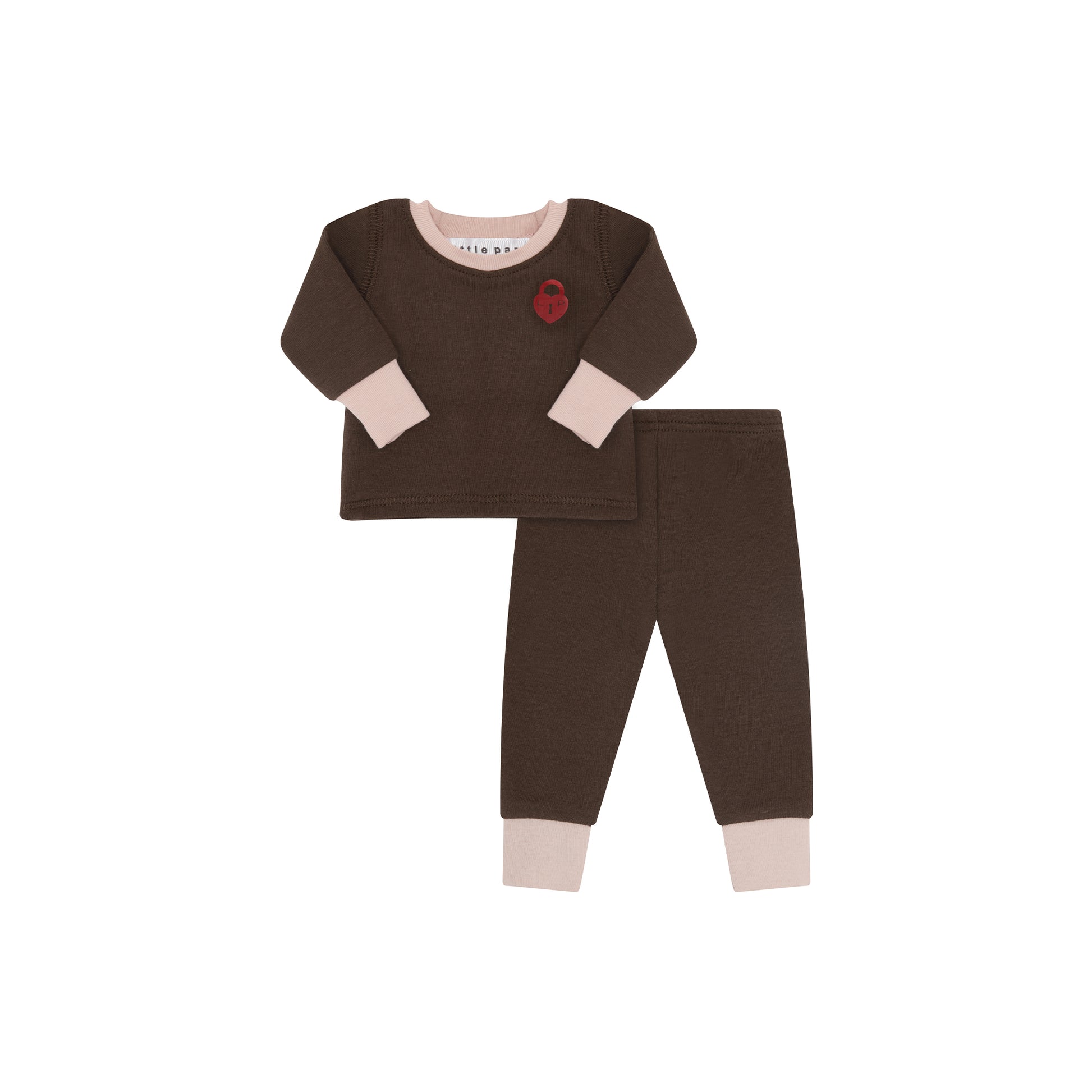 A two-piece baby pajama set in dark brown, featuring a long-sleeve top with light beige cuffs and collar, a small red heart patch on the chest, and matching brown pants with light beige cuffs.