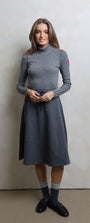 Woman wearing a gray dress with a white background
