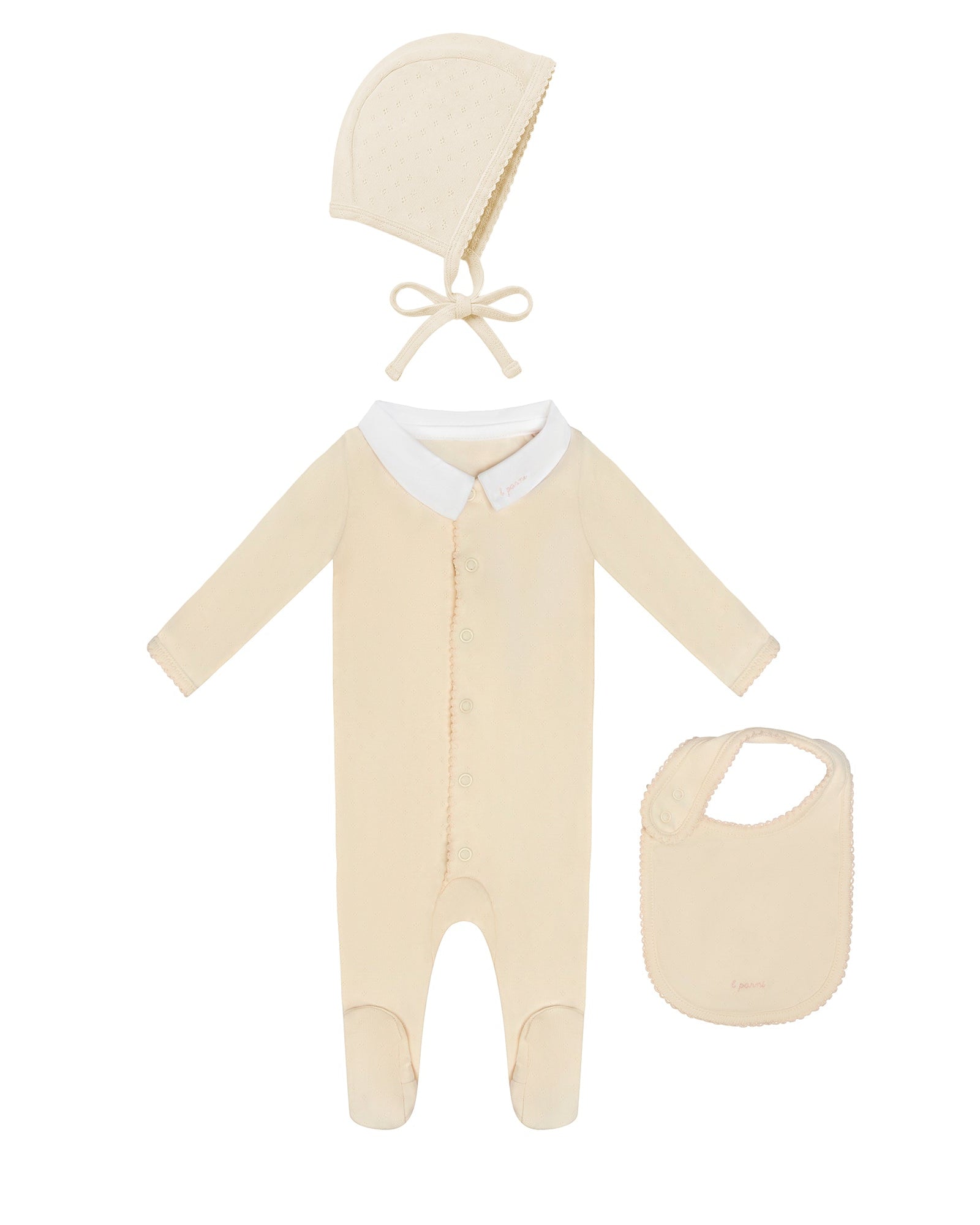 Baby outfit set with onesie, bonnet, and bib on a white background