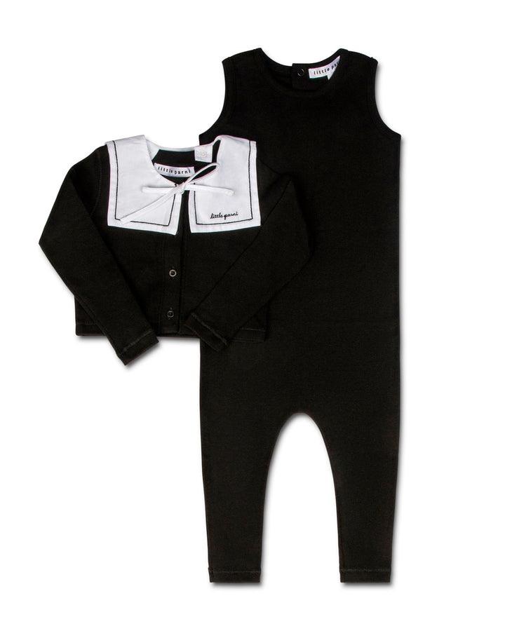 Black baby outfit with white collar and bow tie on a white background