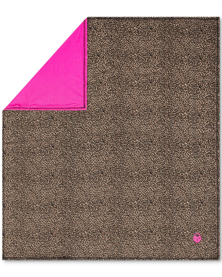 Brown textured blanket with pink corner on a white background