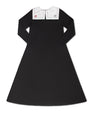 Black dress with white collar on a white background