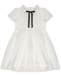 White dress with a black bow on a white background