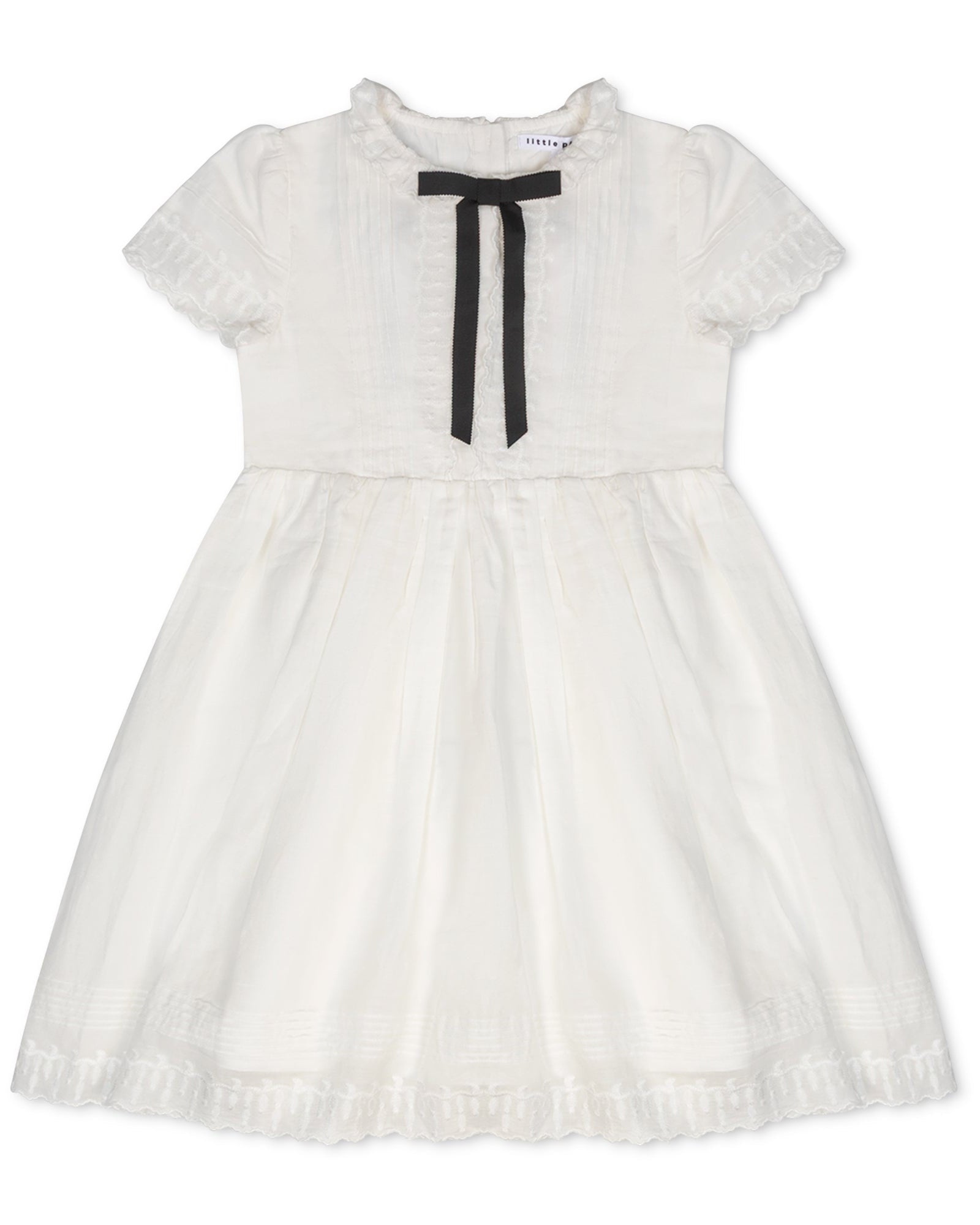 White dress with a black bow on a white background