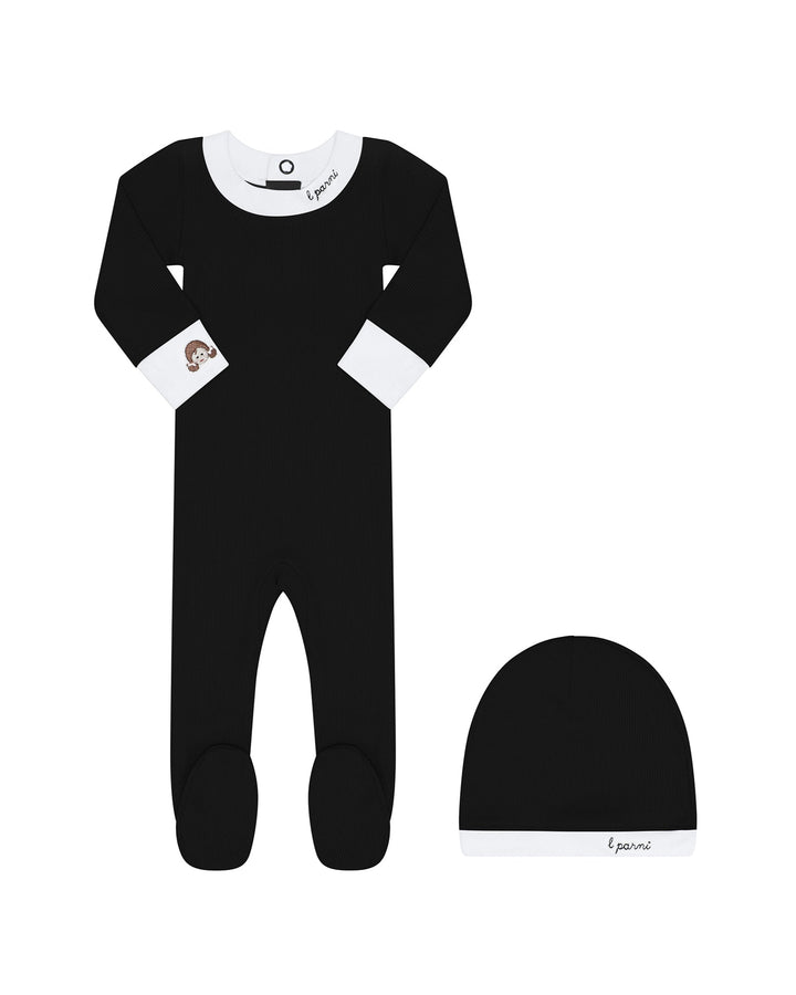 Black baby onesie with white accents and matching hat on a white background