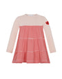 Pink dress with red and white striped skirt on a white background