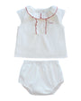 White baby top and bloomers set with red trim on a white background