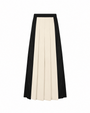 A pleated midi skirt with a color-blocked design, featuring a wide central panel in cream and flanking panels in black, shown against a plain white background.