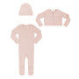 A three-piece baby clothing set in a soft dusty pink color, including a long-sleeve footed sleeper, a matching button-up cardigan, and a knit bonnet, laid out on a solid white background.