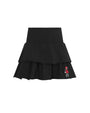 A black tiered ruffle mini skirt with a ribbed waistband and a small embroidered cartoon character on the lower right hem, shown against a plain white background.