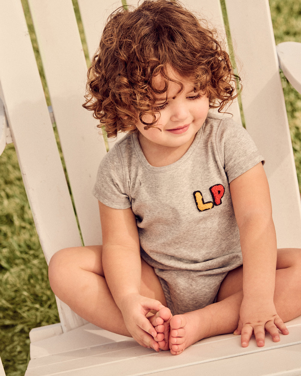 Baby wearing the grey LP Baby Romper.