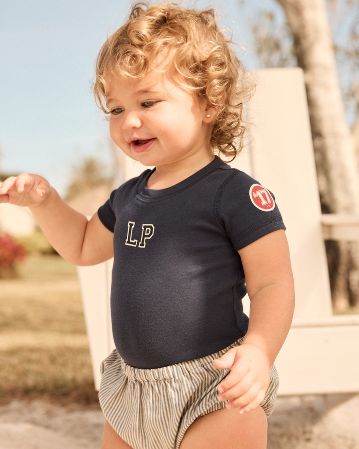 Toddler wearing the LP Est. 17 Baby Bodysuit in Navy.