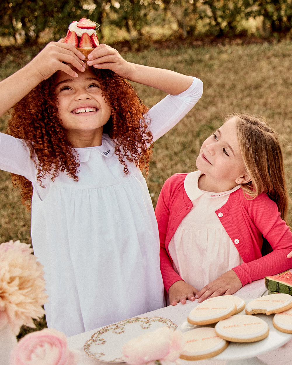 Two girls wearing the Girls Sleeveless Collared Dress and T-Shirt Set. 