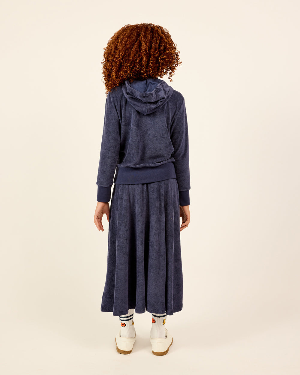 Girl wearing the Girls French Terry Zip-Up Hoodie and Skirt Set showing the back only.