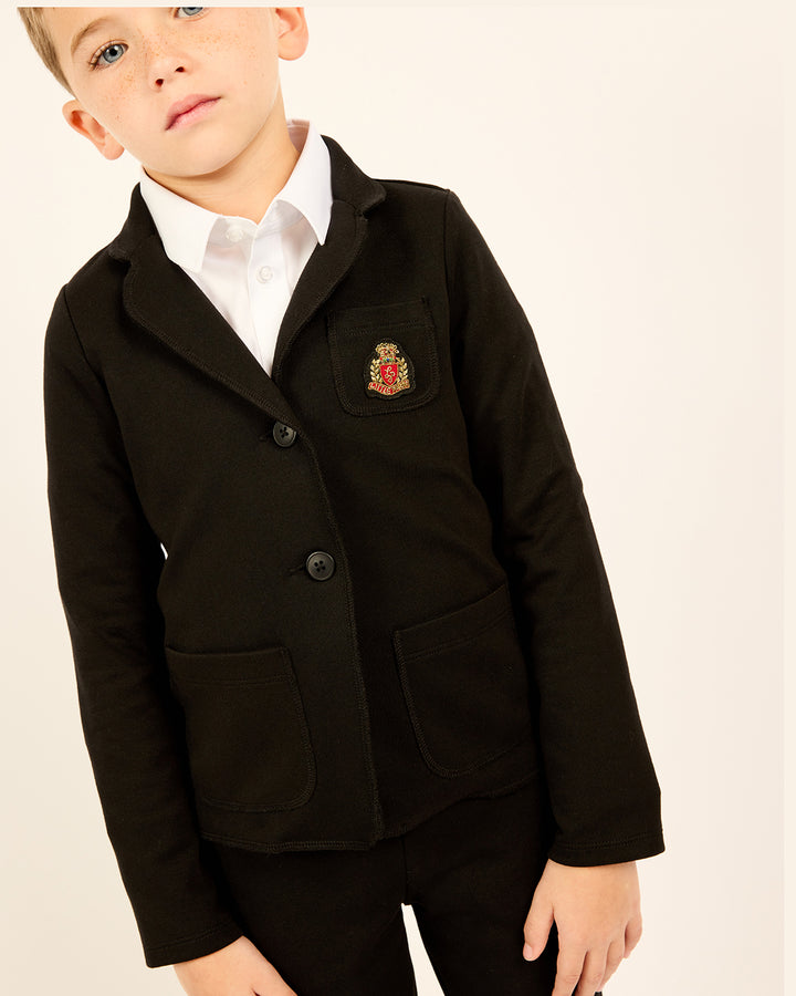 Boy wearing the Milano Classic Blazer with Crest in Black.