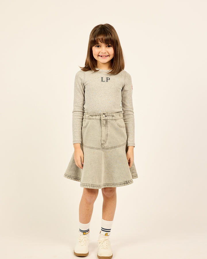 Model wearing the Short Ruffle Denim Skirt in Grey.