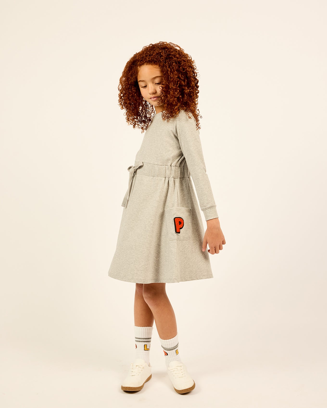 Model wearing the LP Pocket Dress in grey.
