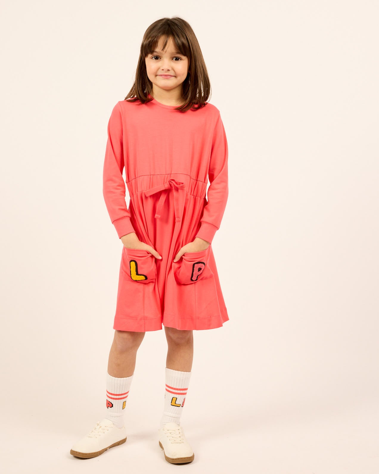 Model wearing the LP Pocket Dress in pink.