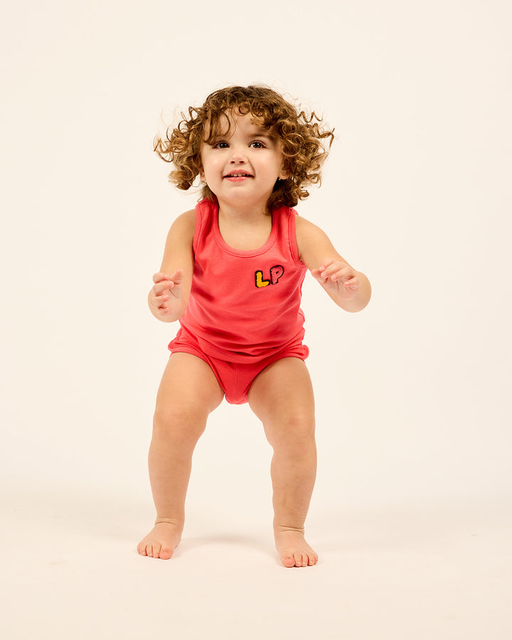 Baby wearing the LP Baby Tank and Short Set in Orange.