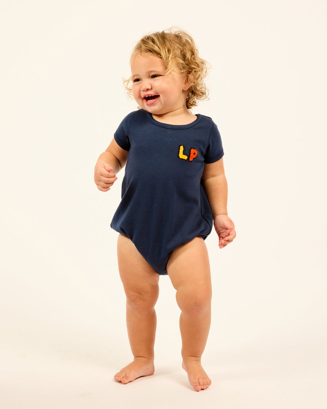 Baby wearing the navy LP Baby Romper.