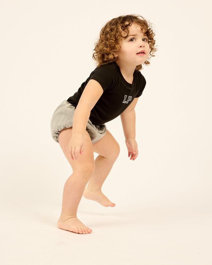 Girl wearing the black Kids LP Est. Short Sleeve Tee.