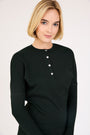 Model wearing the Rhinestone Henley Dolman Sleeve Top in Black.