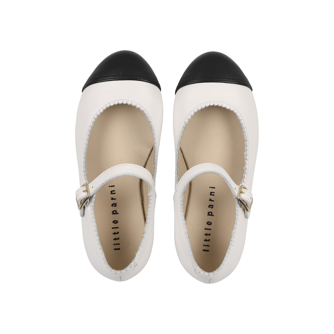 Pair of black and white shoes with 'little parini' branding on a white background