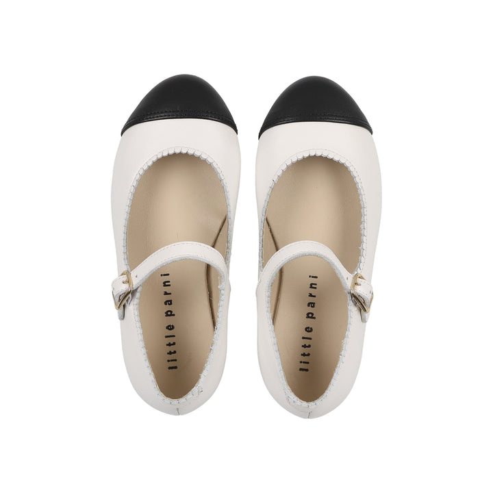 Pair of black and white shoes with 'little parini' branding on a white background