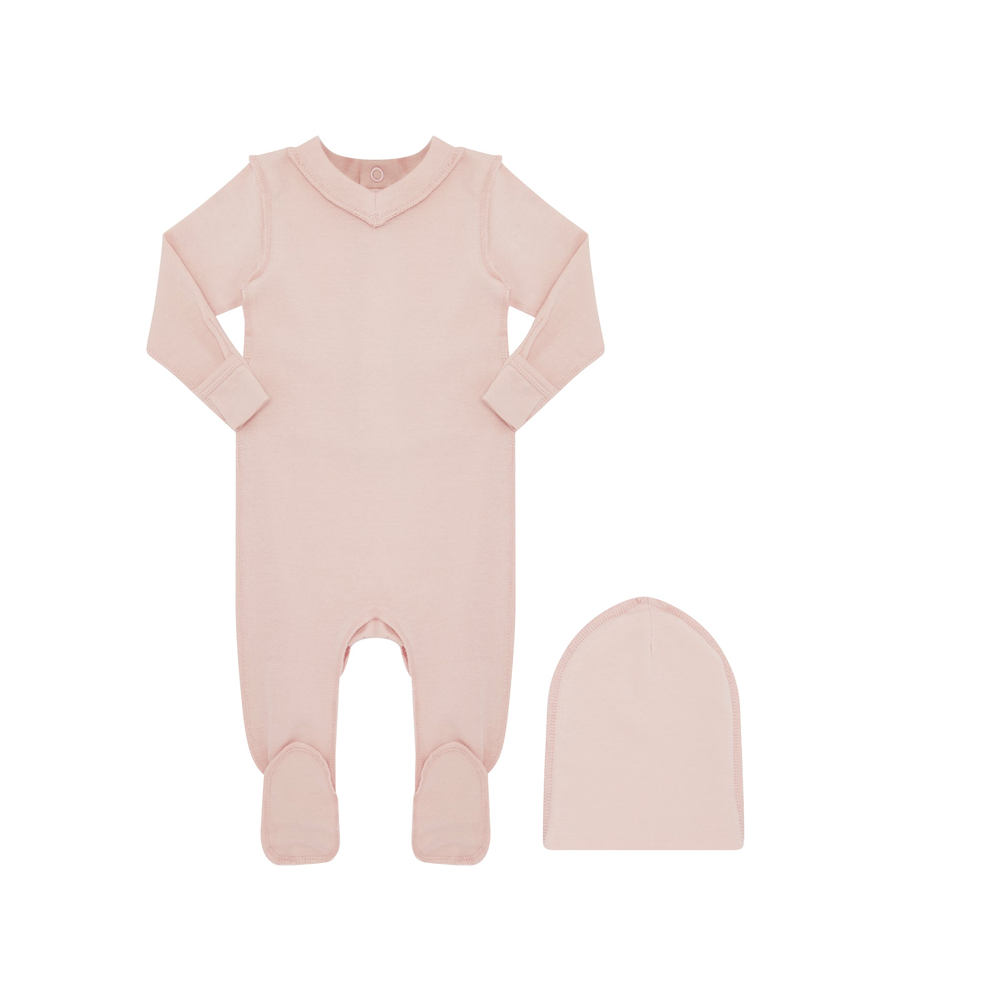 A baby's long-sleeve footed sleeper in a soft dusty pink color, shown next to a matching knit bonnet on a plain white background.