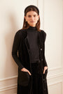 Model wearing the black Sleeveless Velour Cardigan.