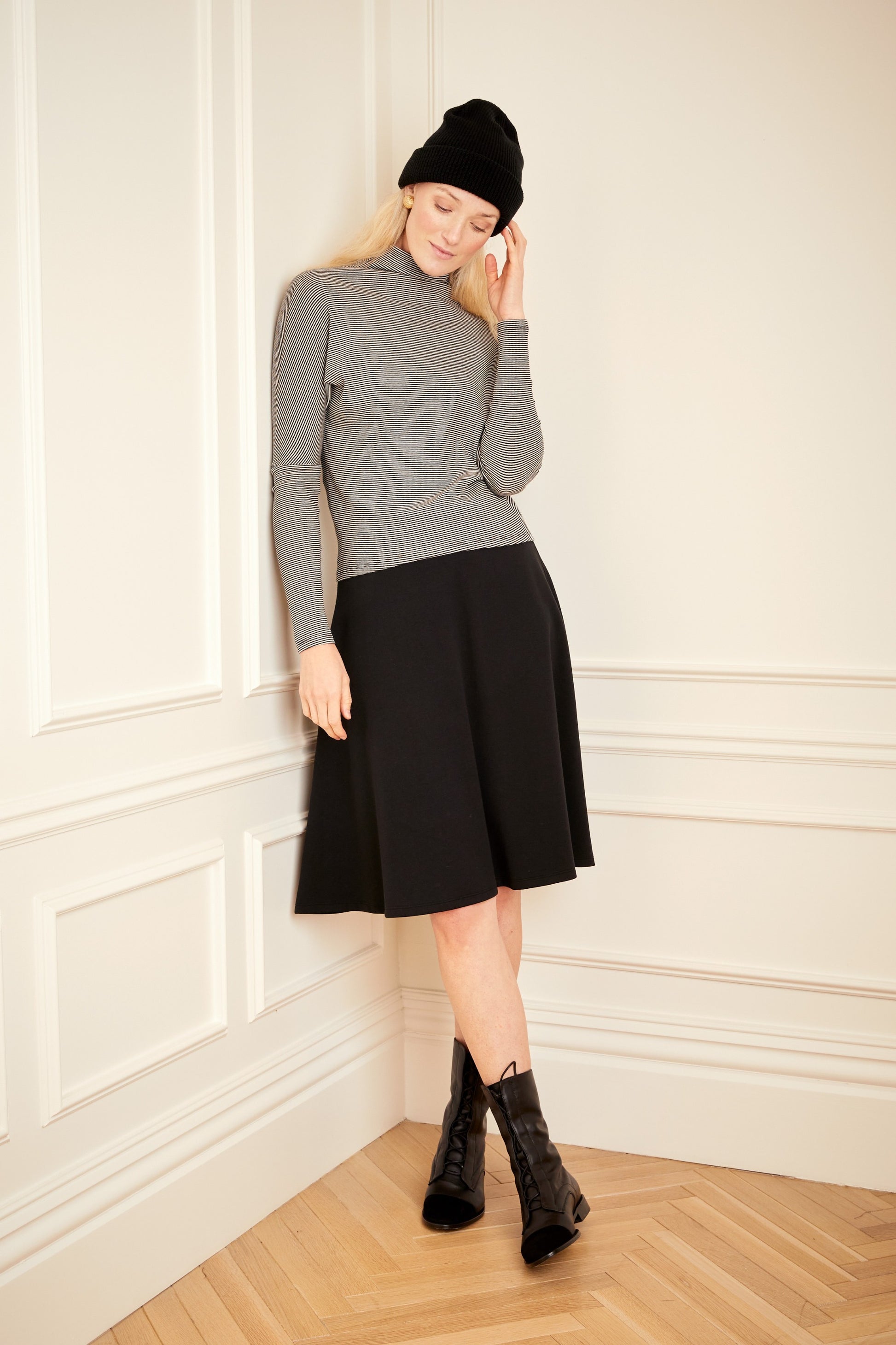 Model wearing the black ivory Striped Dolman Sleeve Turtleneck.