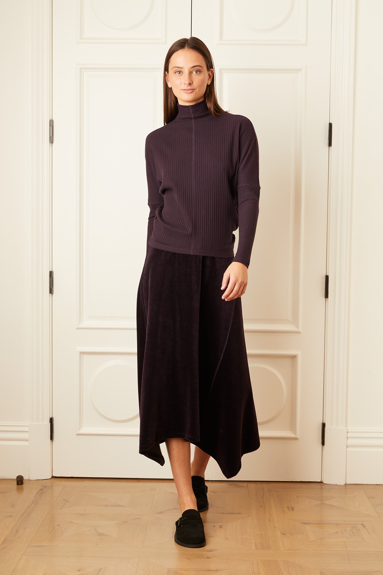 Model wearing the purple Signature Velour Asymmetrical Skirt.