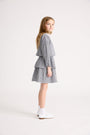 Little girl wearing black and white top and ruffle skirt