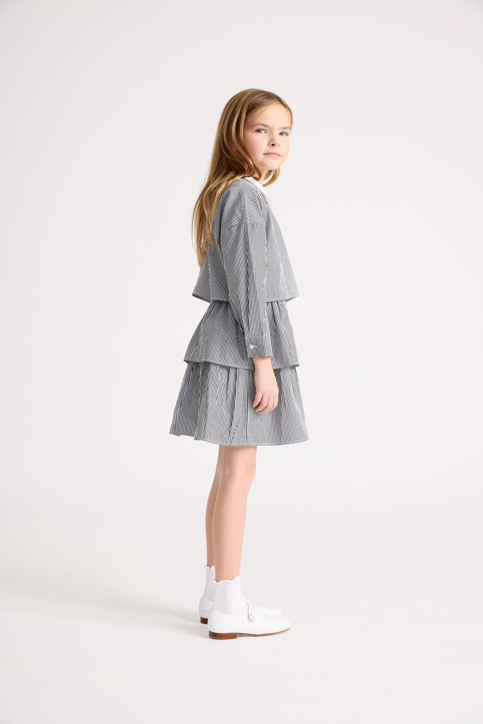 Little girl wearing black and white top and ruffle skirt