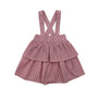 Pink and White striped ruffle skirt with suspenders with a white background
