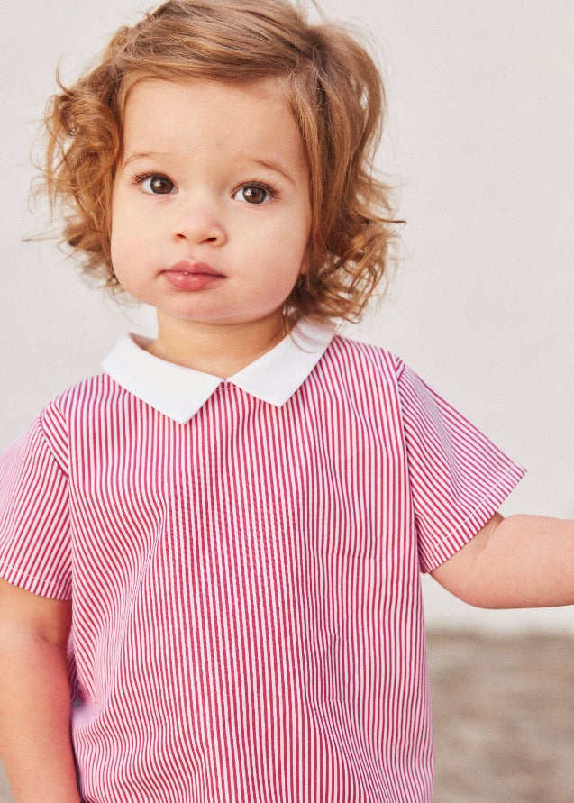 Baby wearing pink and white striped bloomer top