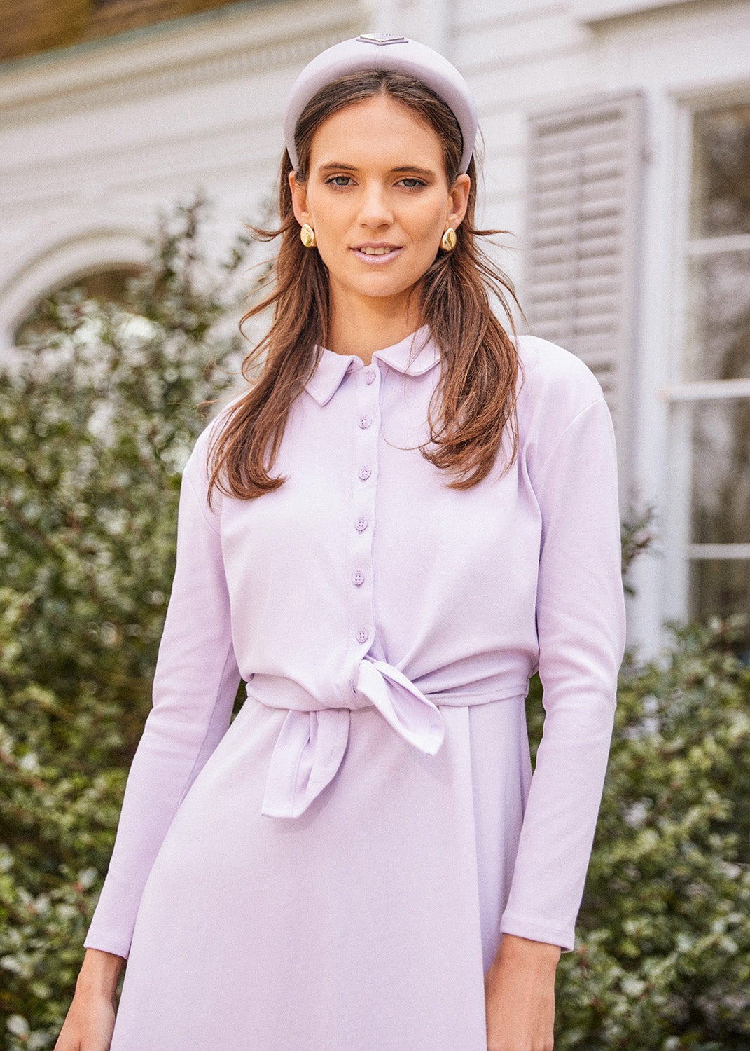 Young woman wearing the Tie Front Button Down Shirt in lavender over matching dress and matching headband