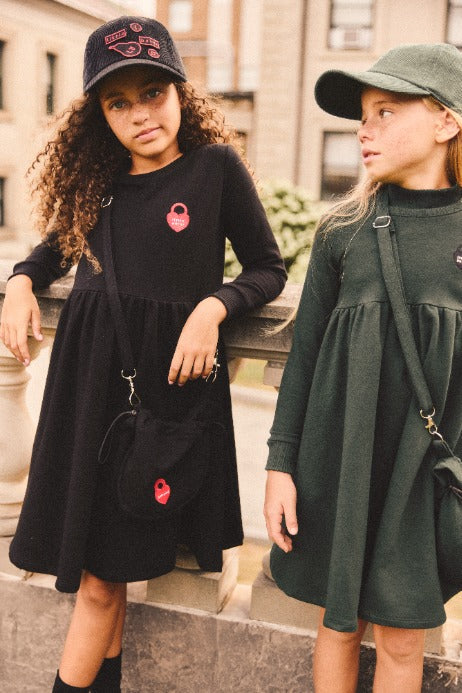 Two girls wearing the Crossbody French Terry Bags in Green and Black.