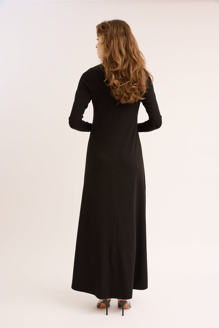 Woman showing the back of the Rhinestone Maxi Dress. 