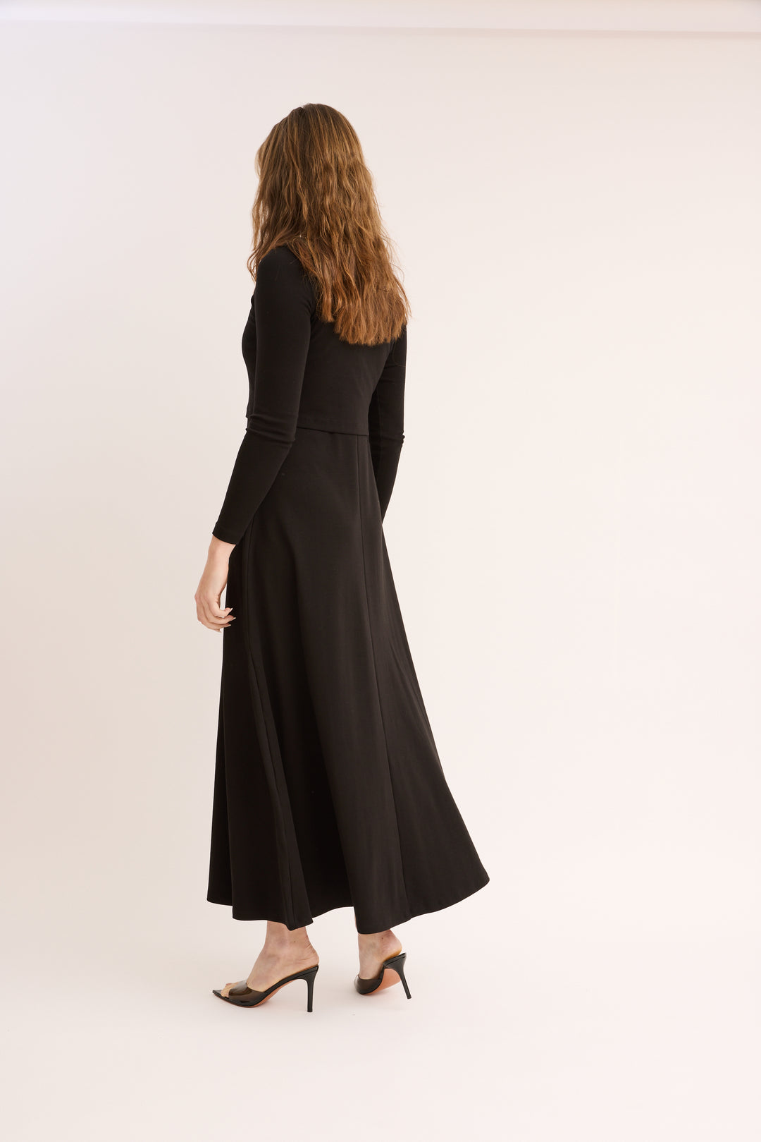 Woman showing the back of the Maxi Jumper Cardigan Set.