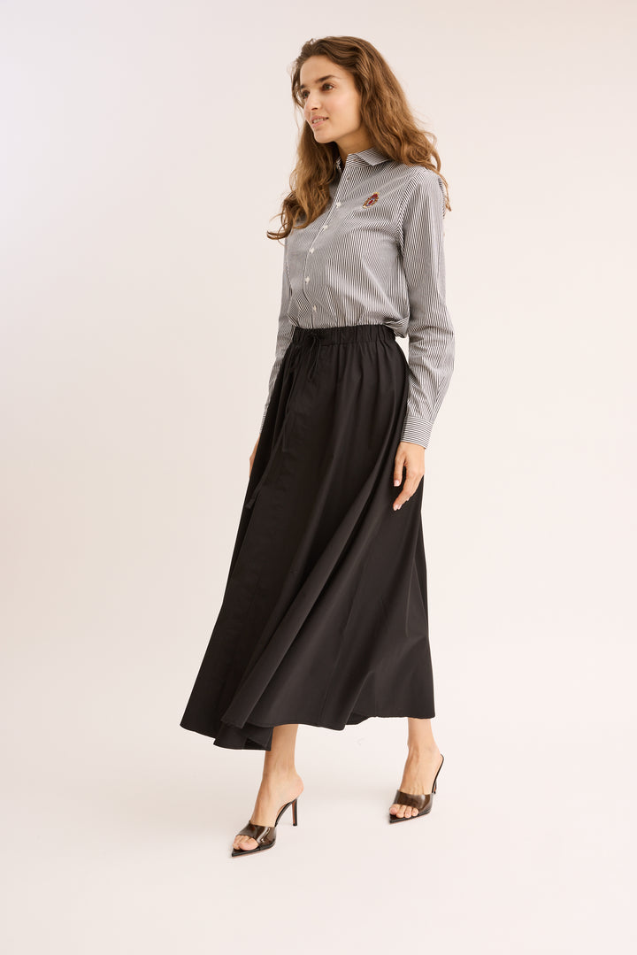 model walking in the Relaxed Cotton Drawstring Skirt.